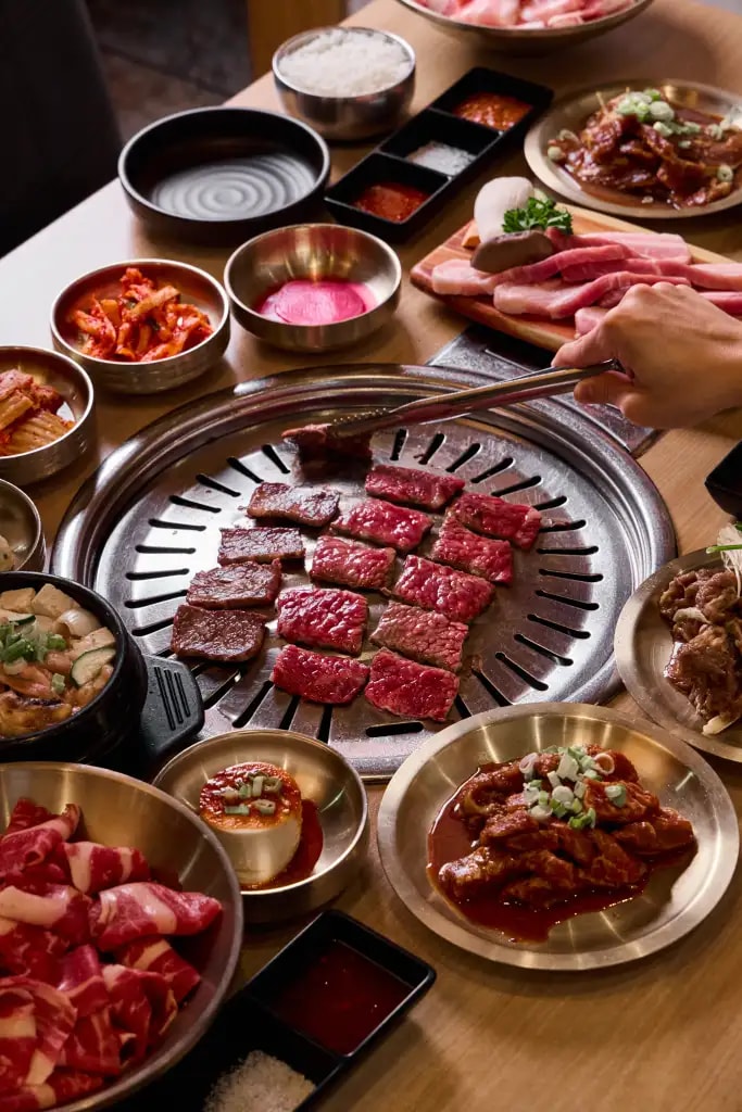 Flat-top grill with assorted meats and sides